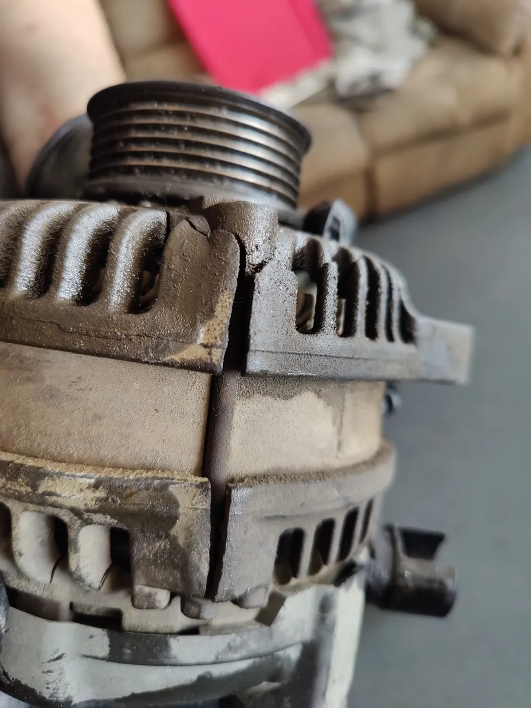 Close-up of a worn alternator case and pulley
