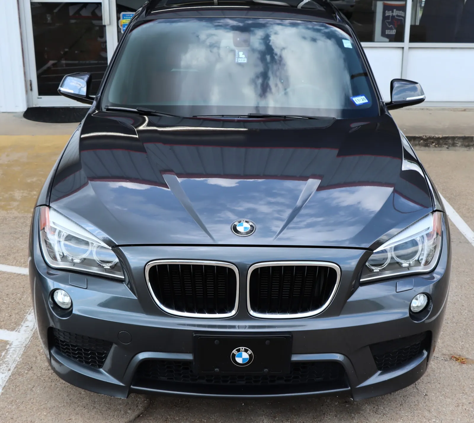 Grey BMW X1 M Sport parked outside the shop