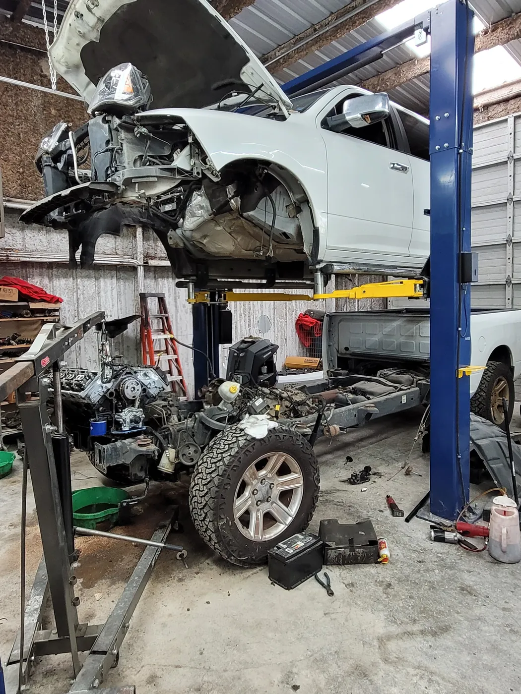 Pickup truck on a lift with its engine and front subframe lowered out