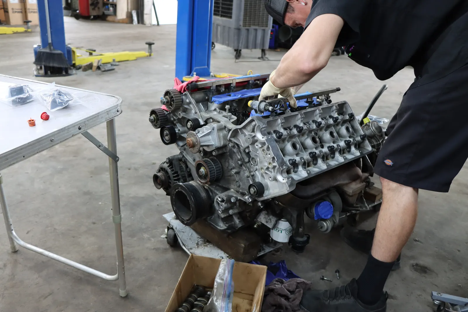 Technician working on a pulled engine on a shop table