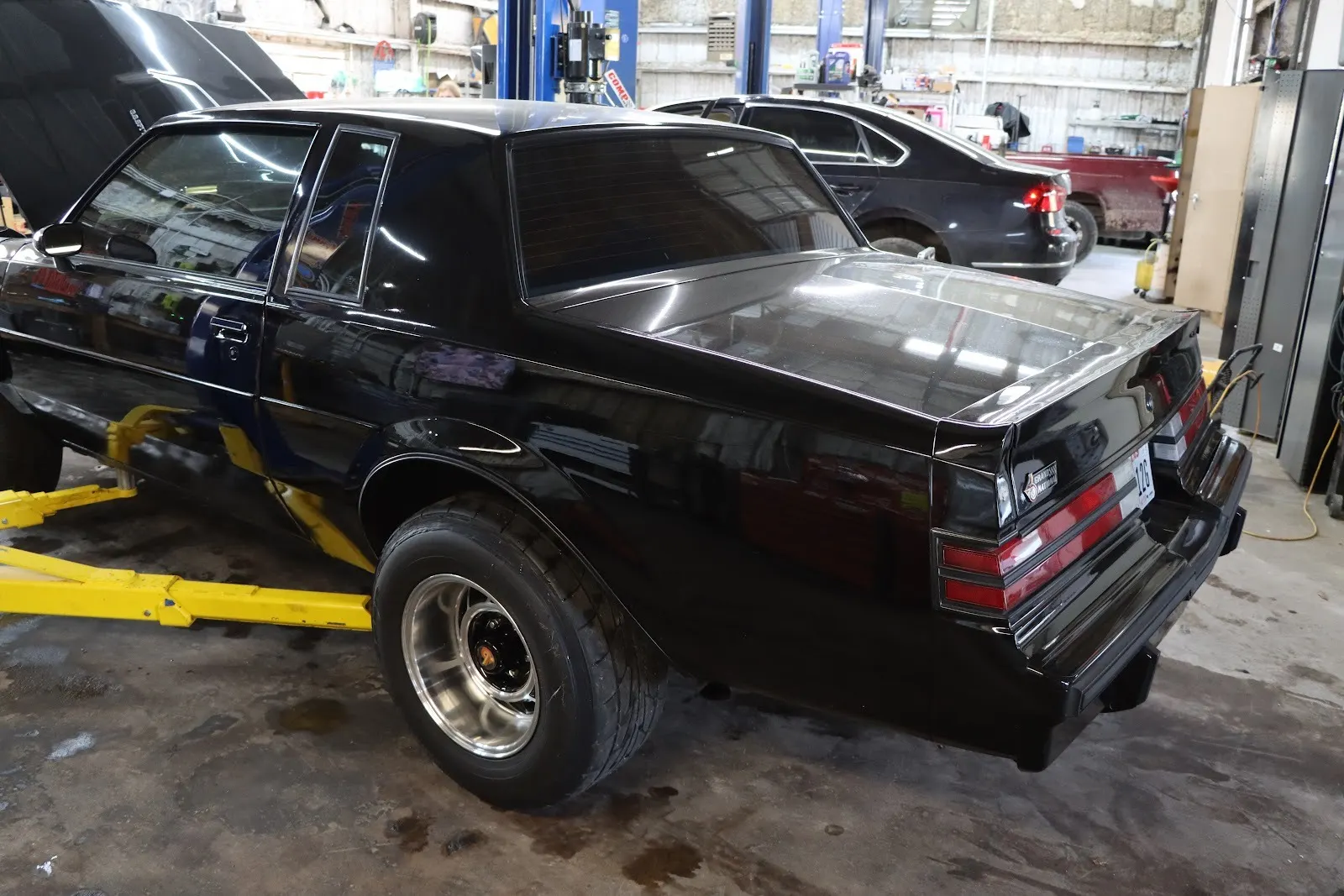 Black Buick Grand National on a lift in the shop
