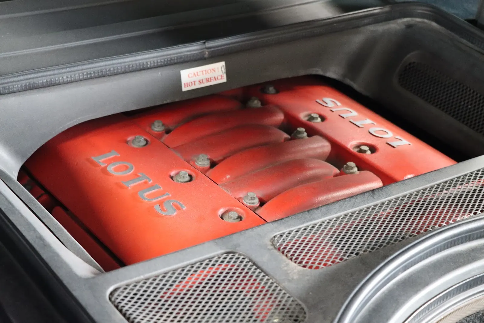 Red Lotus engine cover in an open engine bay