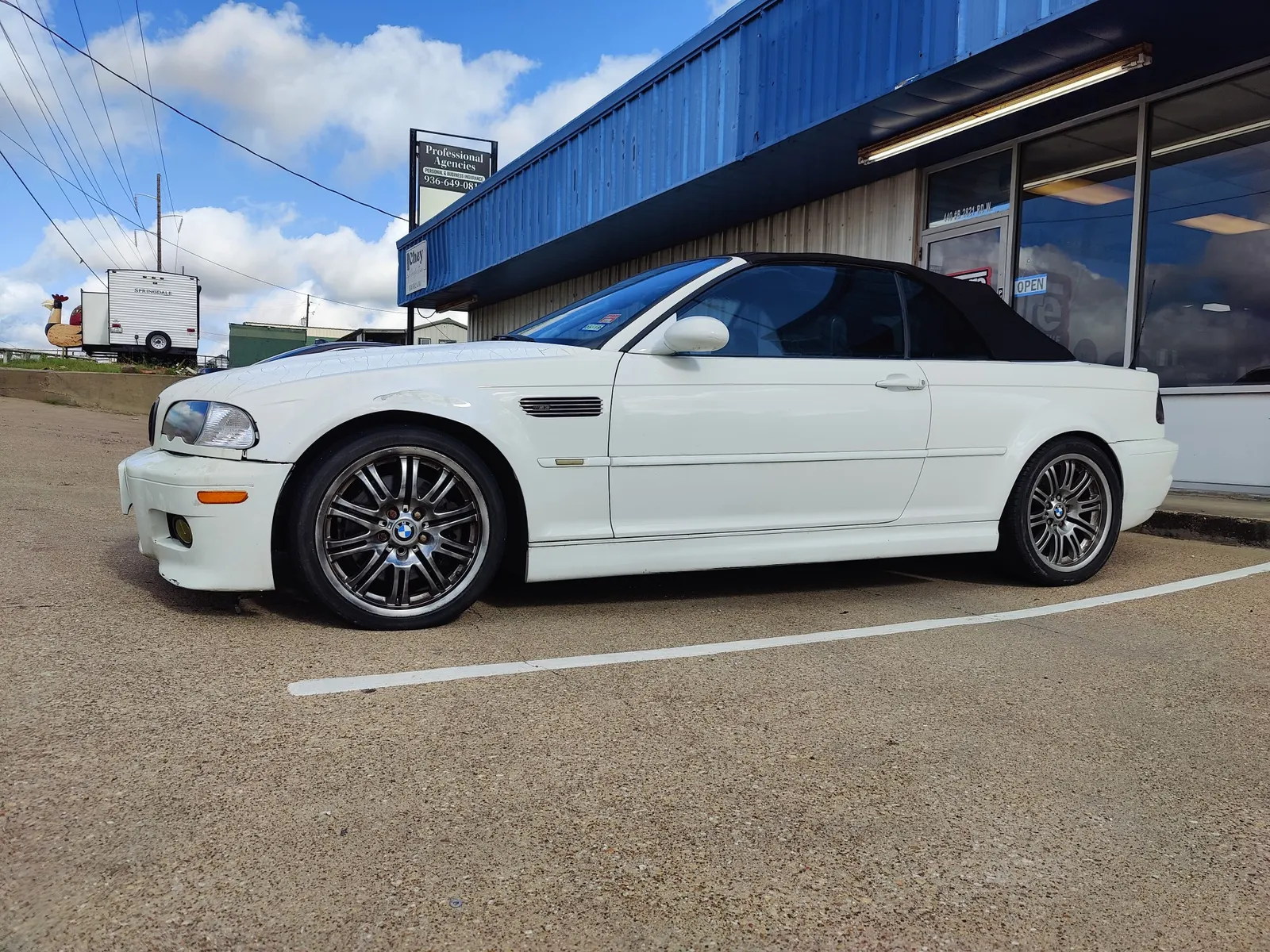 White BMW M3 convertible parked outside the Figure Automotive shop
