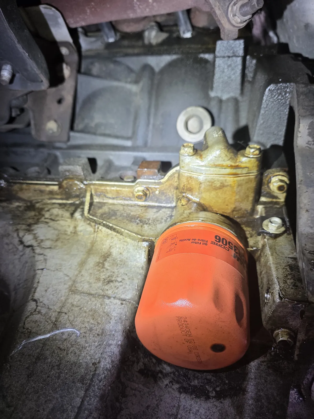 New orange oil filter installed on the engine block