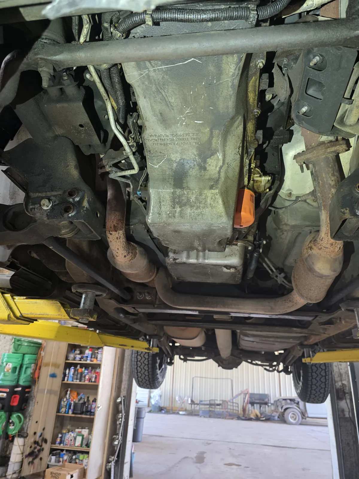 Car raised on a lift for an oil change in the Figure Automotive shop