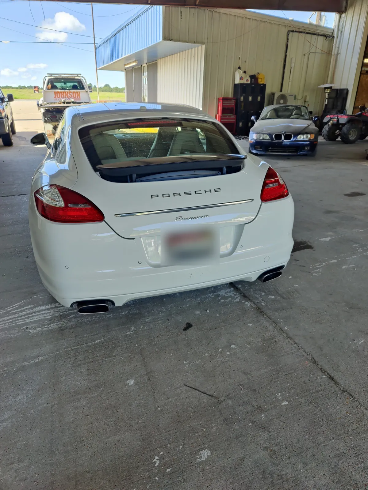 White Porsche Panamera parked in the shop