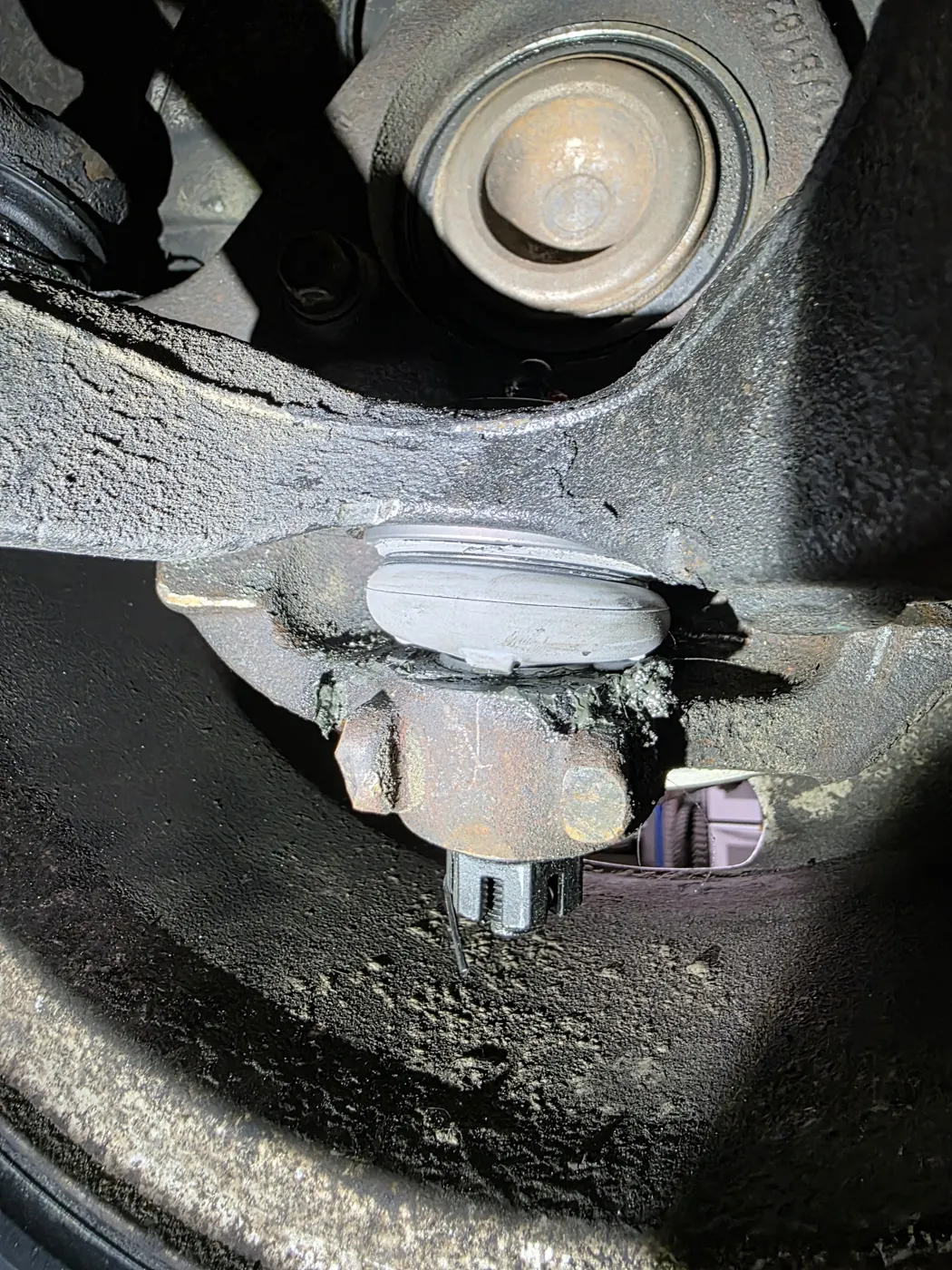 Front suspension and strut mount seen from under the car