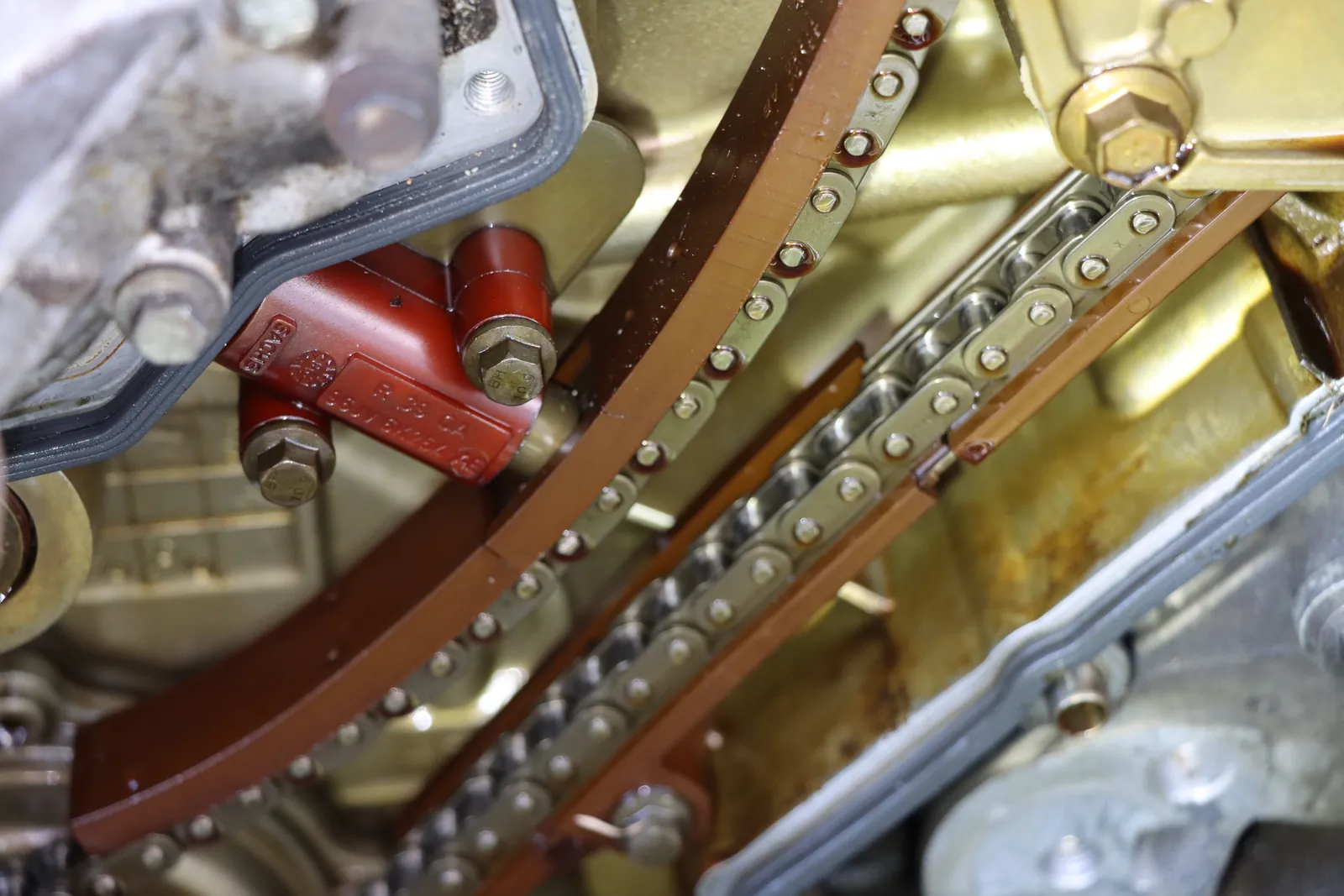 Timing chain, guides and tensioner exposed during an engine repair