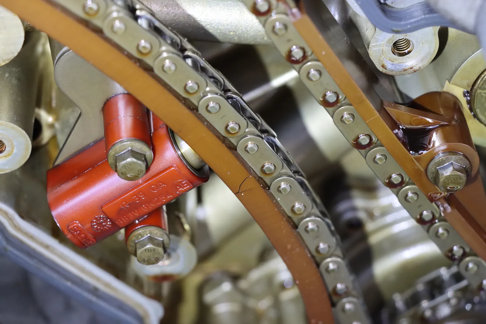 Close-up of a timing chain tensioner and guide rail