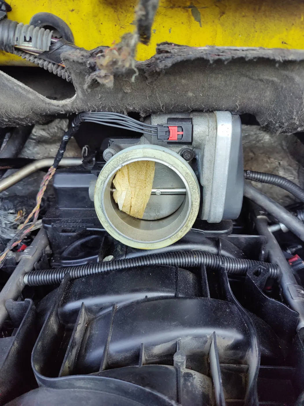 Throttle body with carbon buildup on the intake