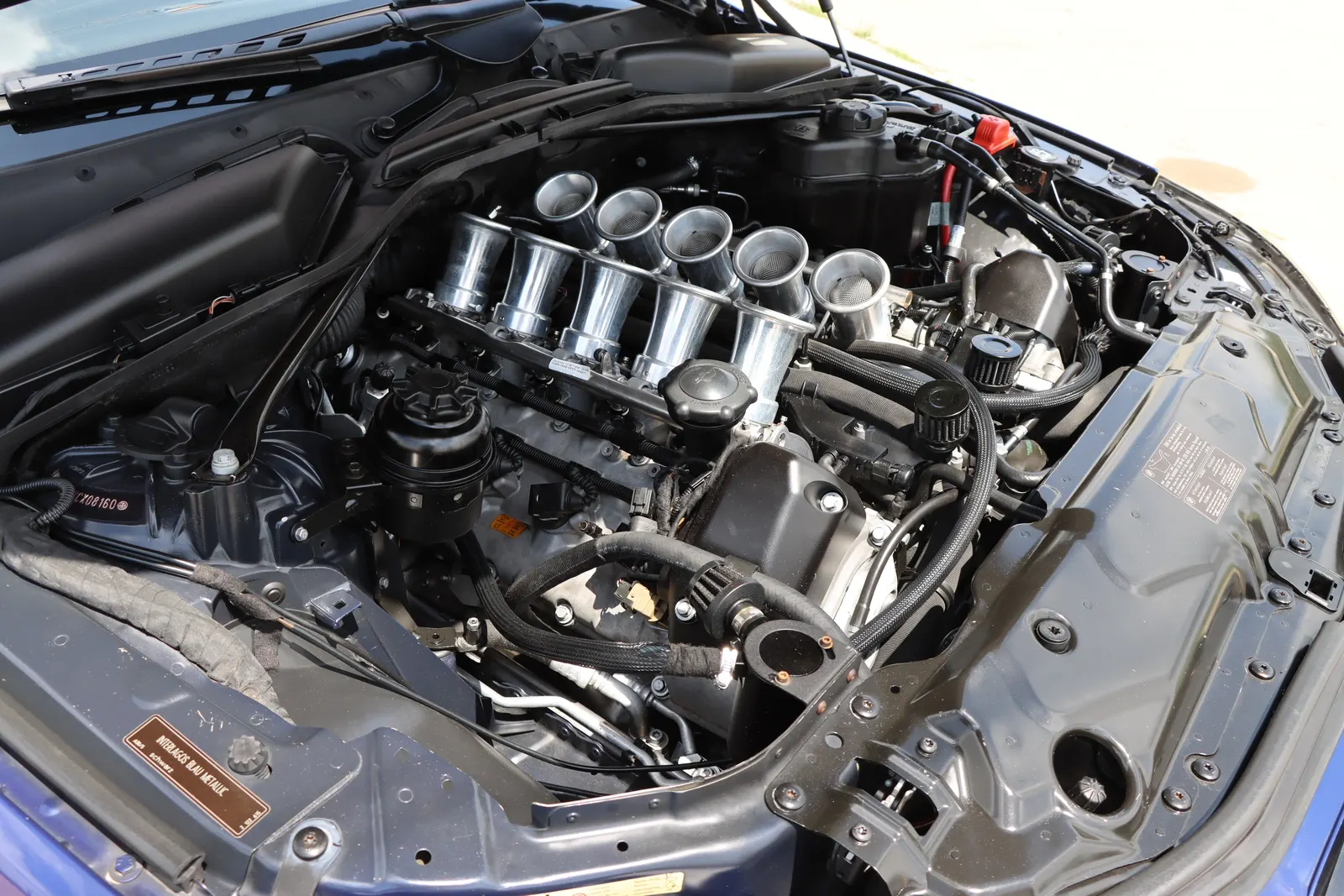 BMW V10 engine bay with the individual throttle bodies exposed