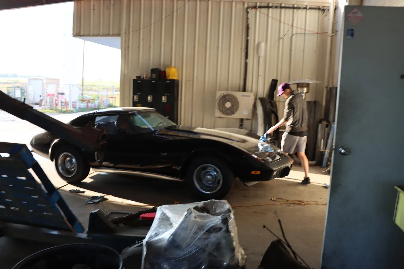 Black C3 Chevrolet Corvette pulled into the shop